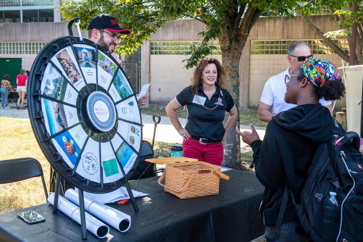 AEED instructors intereacting with a student at event