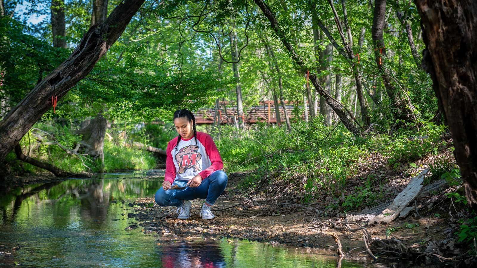 Student outside gathering samples.